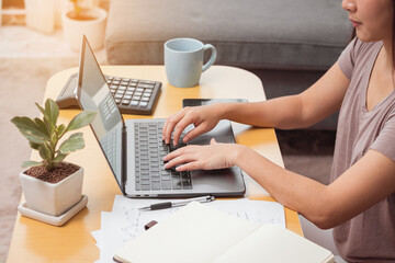 Young woman using laptop for work at home