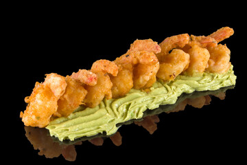 Tasty spicy shrimps with guacamole with reflection, isolated on black background