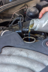 Fototapeta na wymiar Motor oil pouring to car engine