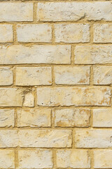 Panoramic background of yellow brick wall texture. Home or office design backdrop, vertical image.