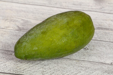 Green tasty mango over wooden background