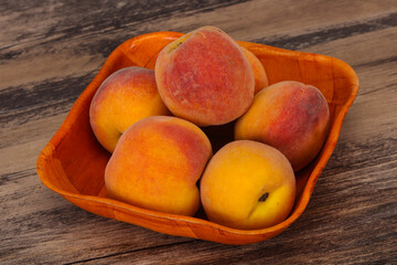Peach heap in the wooden basket