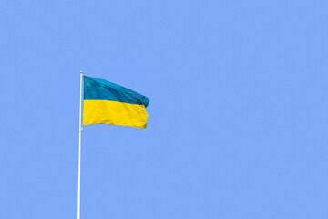 Ukrainian flag on blue sky background. Ukrainian patriotic concept with copy space for text.