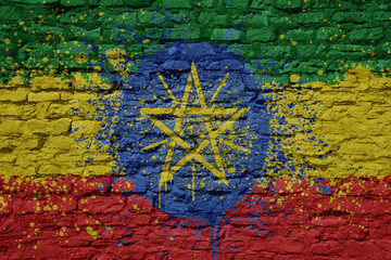 painted big national flag of ethiopia on a massive old brick wall