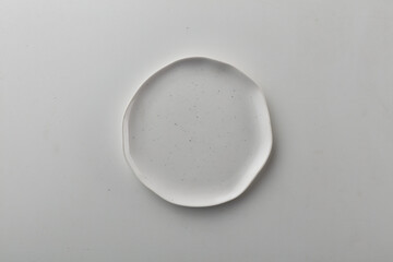 Top view shot of a rectangular white plate on white background.