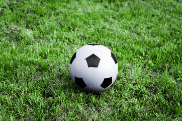 White ball on a green field waiting to be kicked