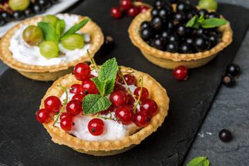 fruit cake on dark background with  currants and gooseberries, healthy desserts