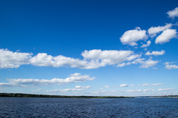 River and sky with cloud. Summer landscape with a view of the wide river. City embankment, view of the other Bank.