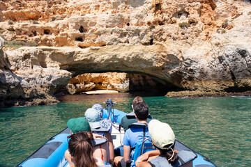 A group of tourist in a boat visiting the caves of Benagil