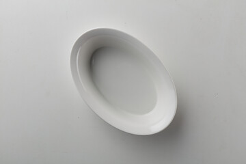 Top view shot of an oval plate on white background.