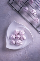 Pink meringue cookies on triangle plate and grate