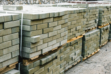 building materials bricks and pipes lie on the ground near the construction site