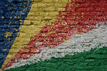 painted big national flag of seychelles on a massive old brick wall