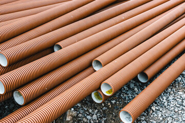 building materials bricks and pipes lie on the ground near the construction site