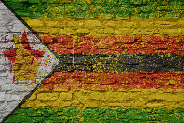 painted big national flag of zimbabwe on a massive old brick wall