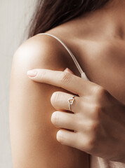 A refined female hand gently touches her bare shoulder. A well-groomed female body. Life style.