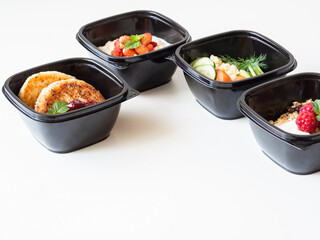 Healthy breakfast delivery. Fitness food. Eat right concept, healthy food, clean food take away in boxes, fried egg and vegetables, oatmeal, granola, cheesecakes