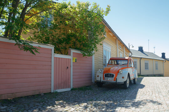 Porvoo, Finland - 3 June 2020: Beautiful street with blooming white lilac and vintage car Citroen 2CV in old town of Porvoo
