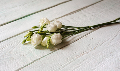 bouquet with small buds of white roses flowers on a light background