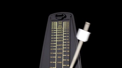 The metronome beats a slow rhythm on a black background
