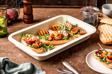 Grilled vegetarian baguette  sandwiches with arugula, grilled peach, black sesame and almond