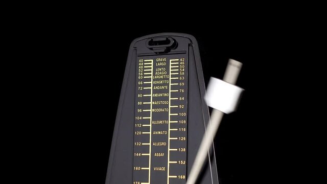The metronome beats a slow rhythm on a black background
