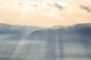 Sun shining valley light rays fog clouds sky