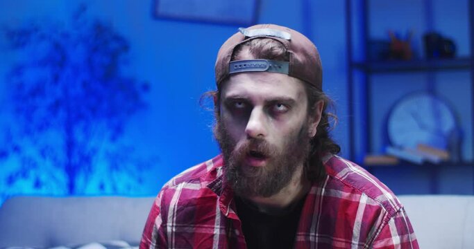 A frightening zombie man scaring people during the apocalyptic period. An eerie hungry living dead looking at camera. Virus, pandemic concept.