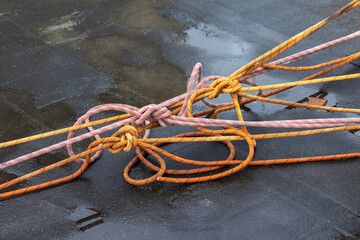 Tied in knots and stretched climbing ropes on roof of a building. Roof jumping concept.