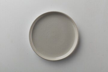 Obraz na płótnie Canvas Top view shot of a plate on white background.