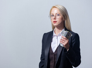 Beautiful blonde businesswoman in suit with money