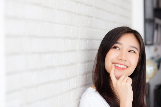 Beautiful young asian woman think idea, planning with inspiration with cement and concrete background, girl thought future and dream, expression of positive, female with healthy, lifestyle concept.