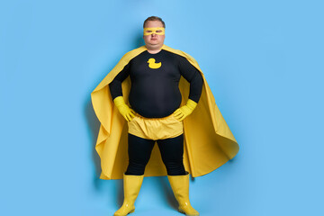 cleaning superhero saves the world from dirt, man has duck picture on costume, he is in yellow wear...