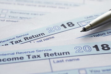 Obraz premium Annual tax reporting. Tax form on the table. Financial statements for signature.