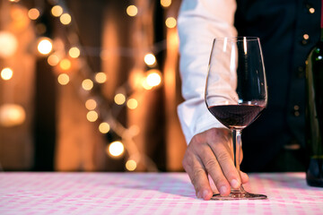 Waitress man pouring wine into glass