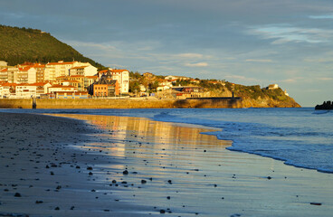 view of basque town Lekeitio and Karraspio beach at dawn