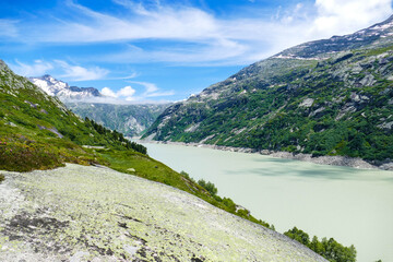 Naklejka na ściany i meble View from a hiking trail next to a glacier lake