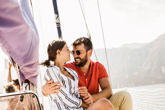 Loving couple spending happy time on a yacht at sea. Luxury vacation on a seaboat.