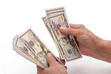 Hands counting US dollar banknotes.
