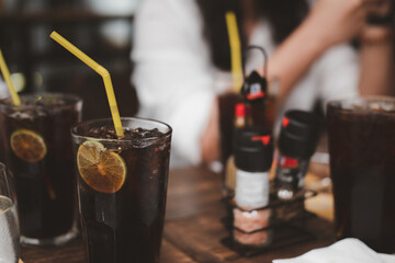 Soft drink with ice and lemon slice inside glass