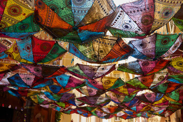 colorful umbrellas over a sunny street