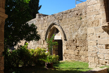Fototapeta na wymiar The arched entrance in the stunning Bellapais Abbey. White Abbey, the Abbey of the Beautiful world. Kyrenia. Cyprus...