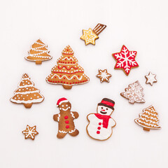 handmade gingerbread cookies in the form of snowflake, snowman,christmas trees and ginger man on white background.