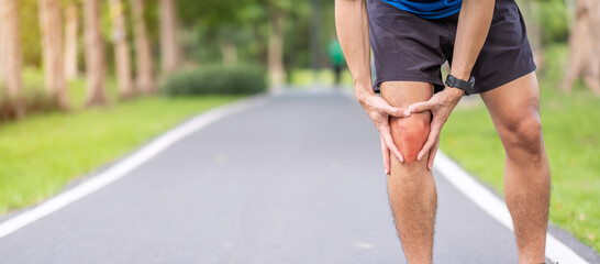 Young adult male with muscle pain during running. runner have knee ache due to Runners Knee or...