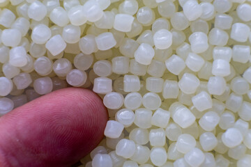 White plastic beads on wood  background, Polymers bead or polymer resin, polymer pallet, Product...