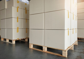 Stack of cardboard boxes on wooden pallets. package box, packaging. Manufactiring warehouse cargo shipment boxes. Logistics and transportation.