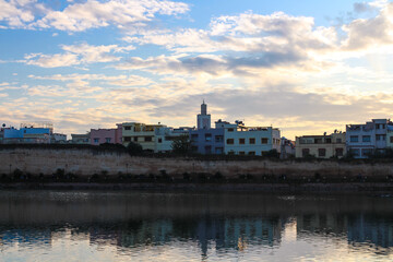 Fototapeta premium View of the embankment, Bassin Souani, colorful houses and a mosque. Menkes. Morocco