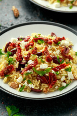 Orzo Pasta with sunshine dry tomato, black olives, walnut and feta cheese