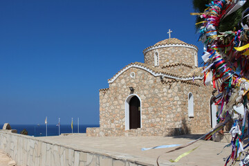 The wish tree is all in multicolored ribbons, followed by the Church of St. Elijah in Protaras. Cyprus.
