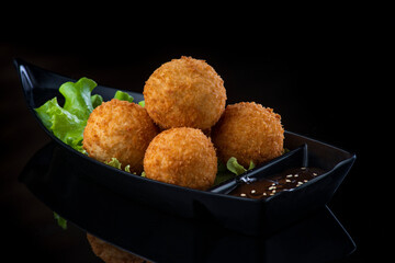A box filled with different types of food. cheese balls